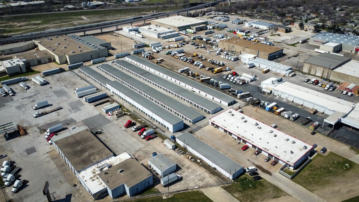 Large fulfillment warehouse interior with rows of shelving and workers picking orders